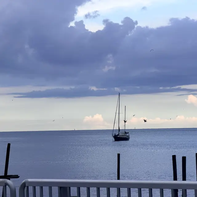 Sailboat anchored off Clearwater, Florida, under evening clouds